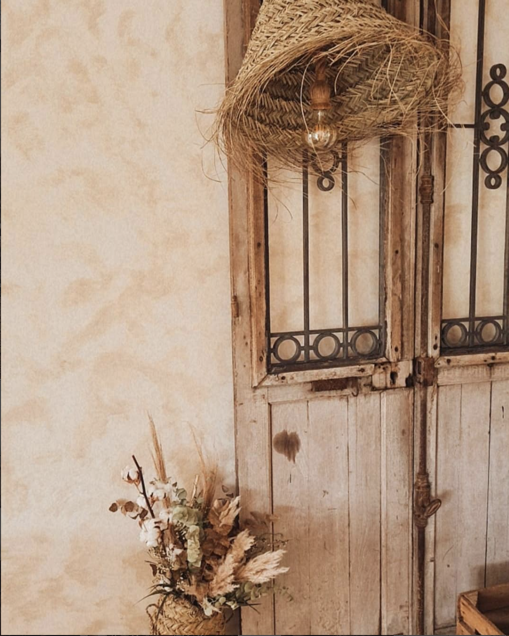 Recanto com porta antiga, fibras naturais e arranjo floral seco